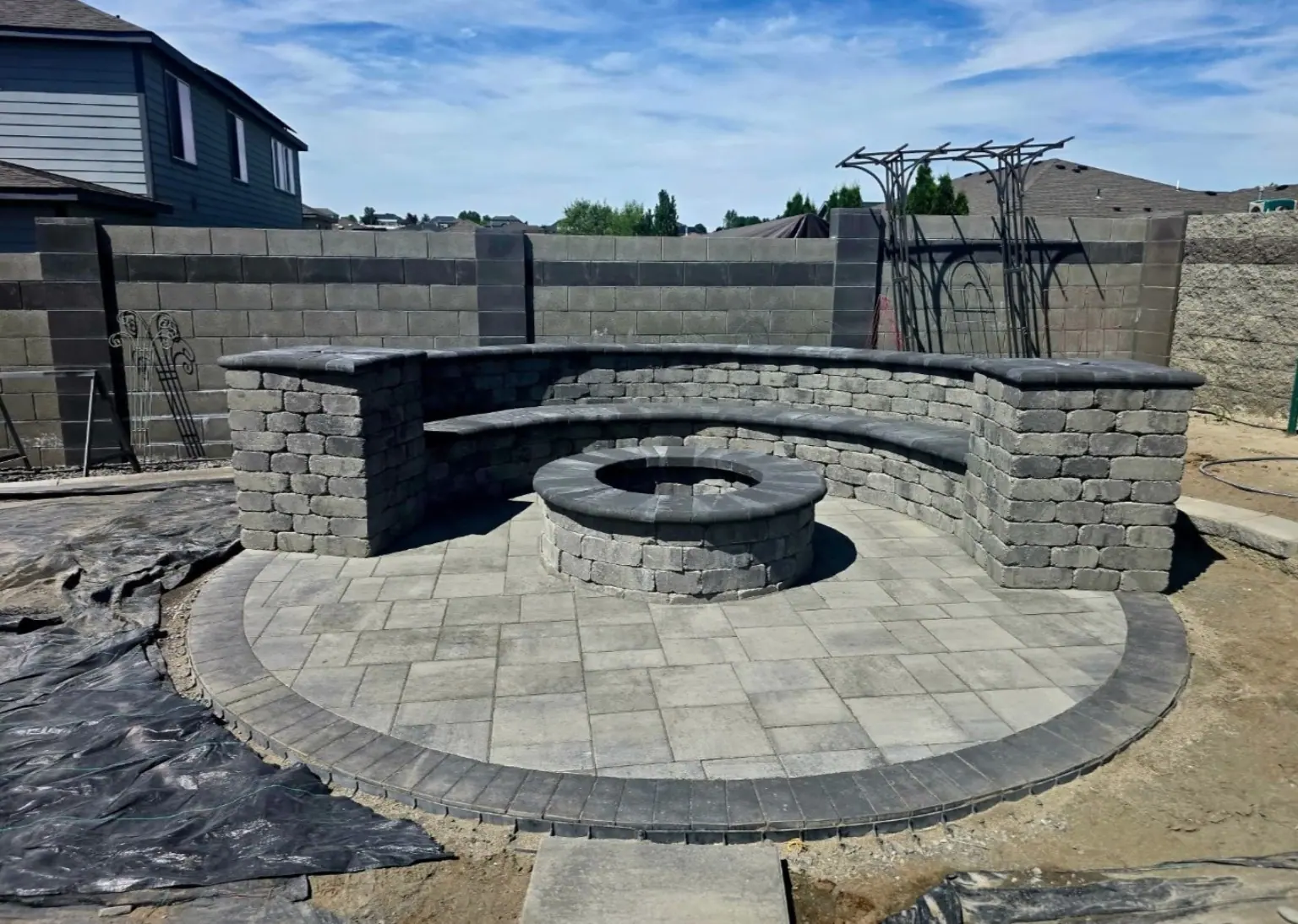 Paver patio with a block fire pit and seat wall